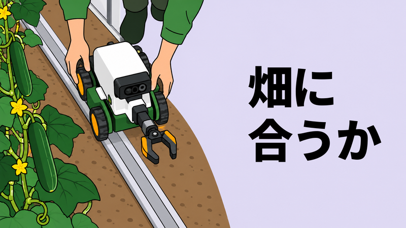 温室を真上から見下ろし、生産者の両手がカメラと収穫ハンド付きの小型ロボットを畝間レールへ載せて適合を確かめる場面。
